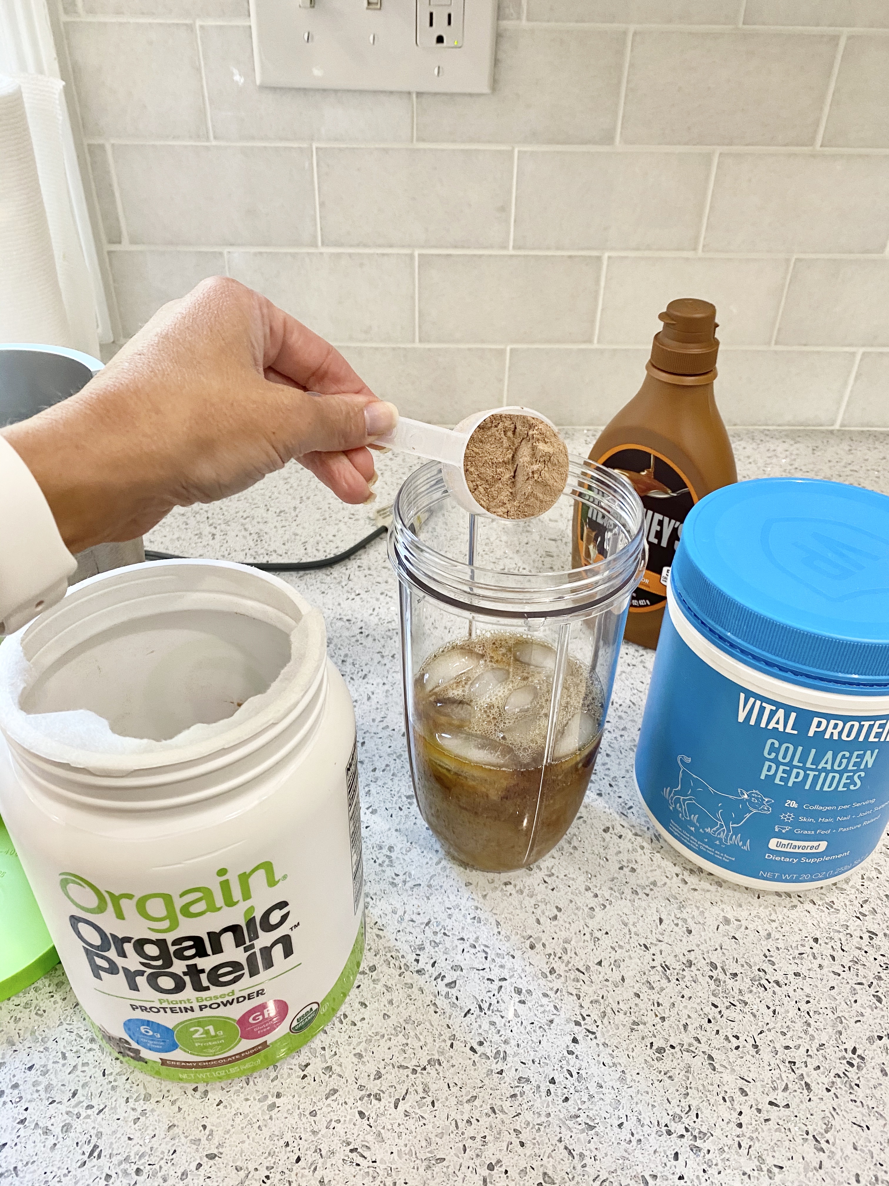 person adding organic protein powder