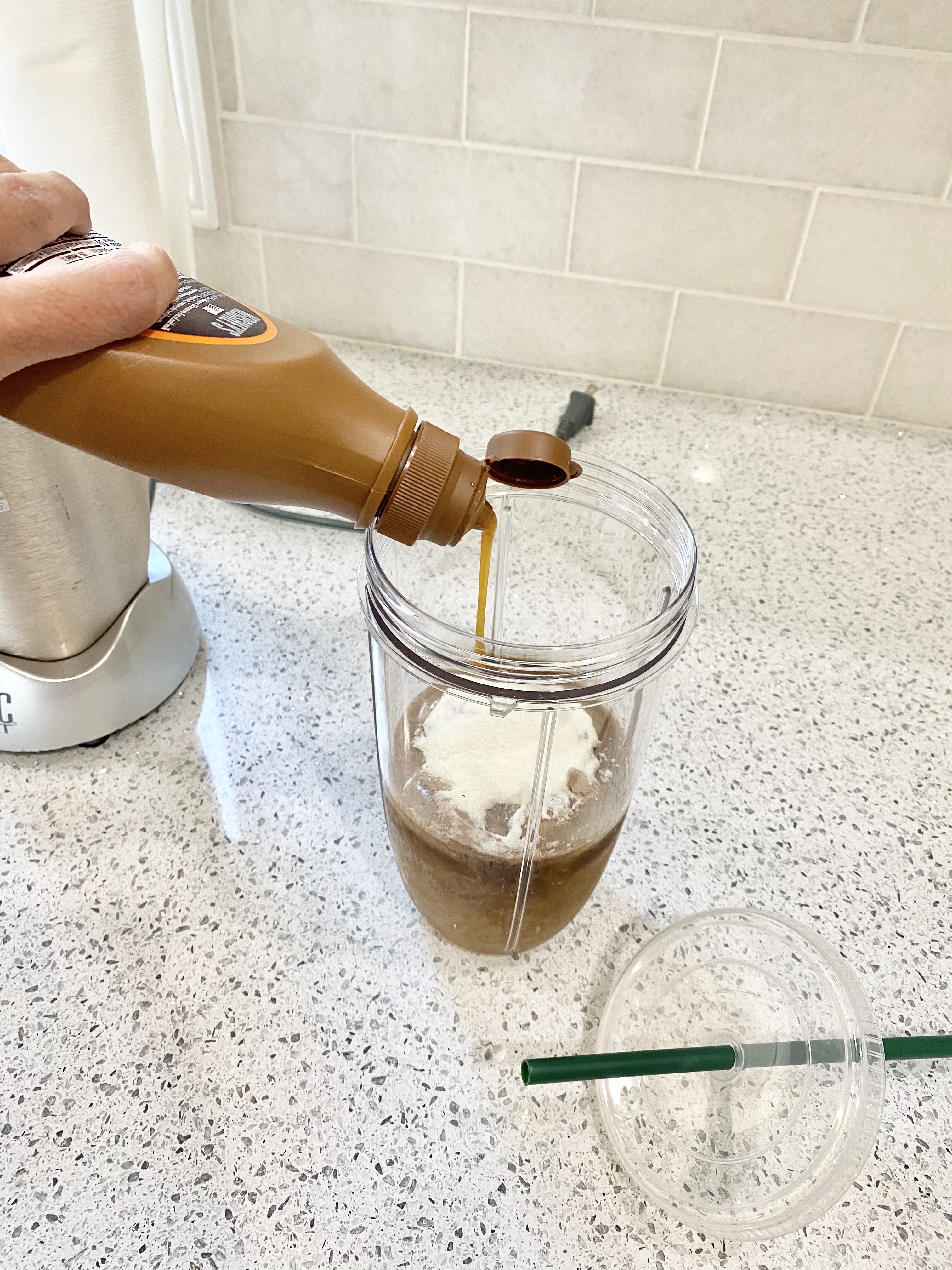 person adding Caramel in Protein Iced Coffee