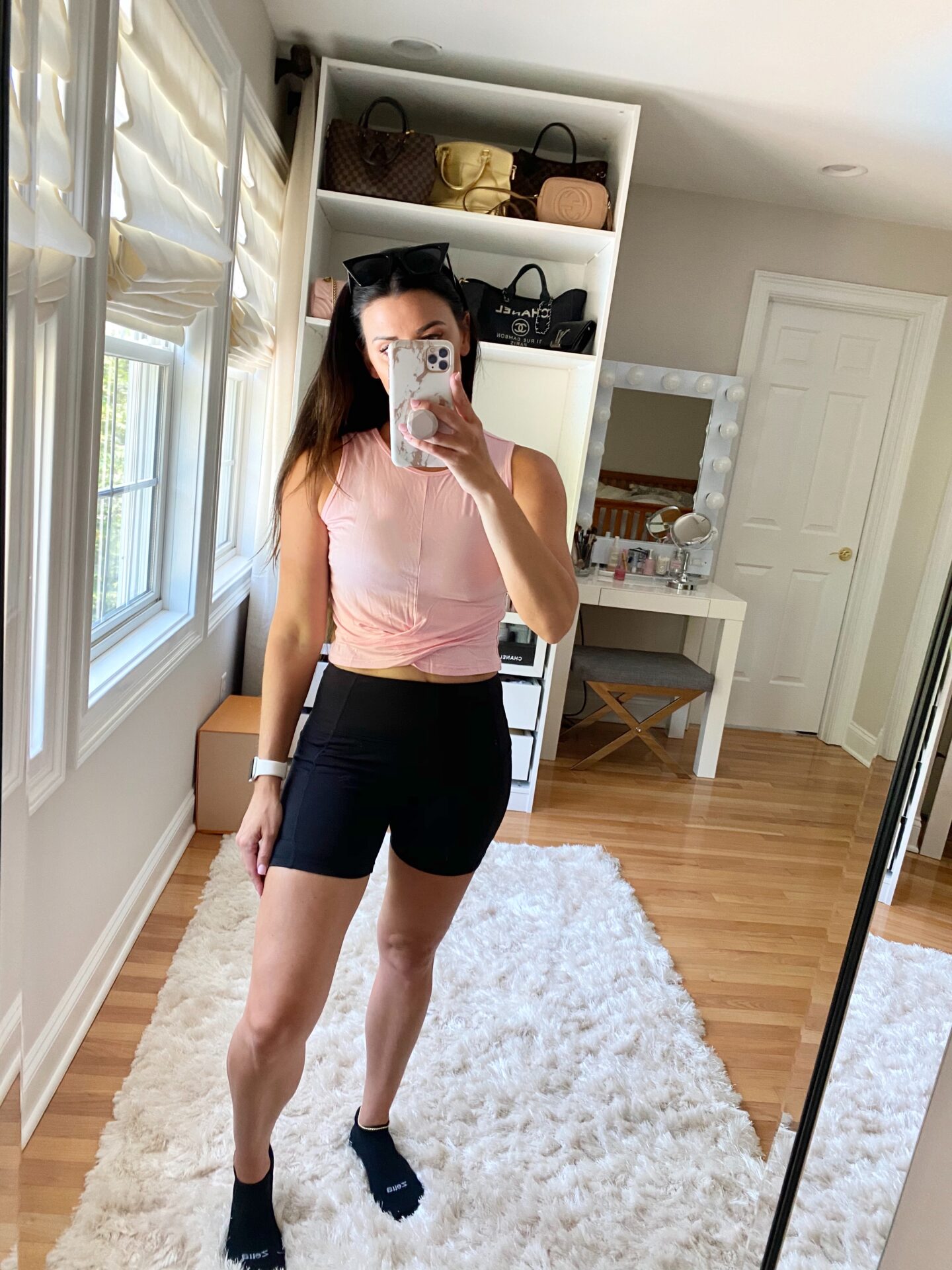 woman wearing shorts and pink top