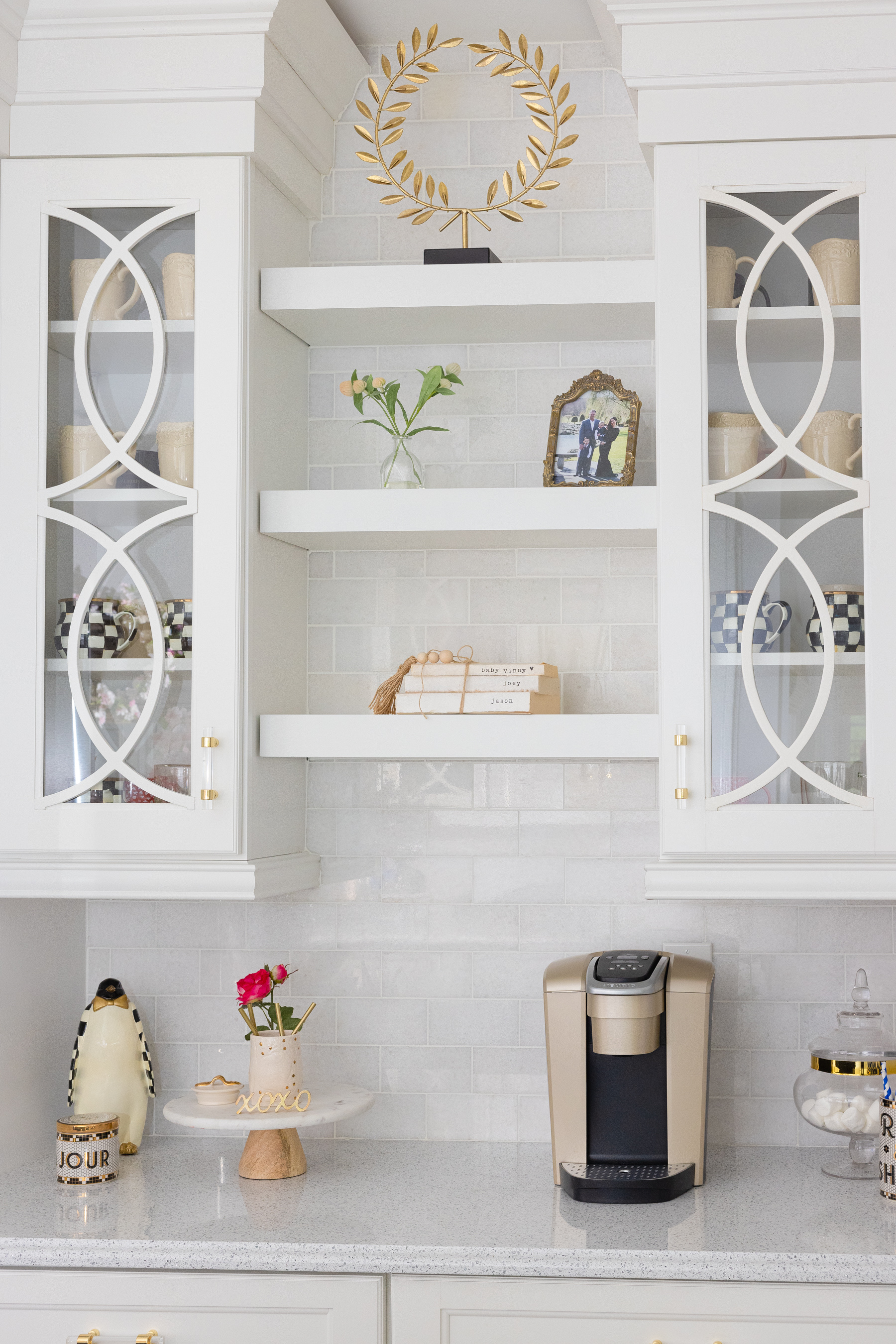 coffee maker, cake stand, and mugs in the kitchen