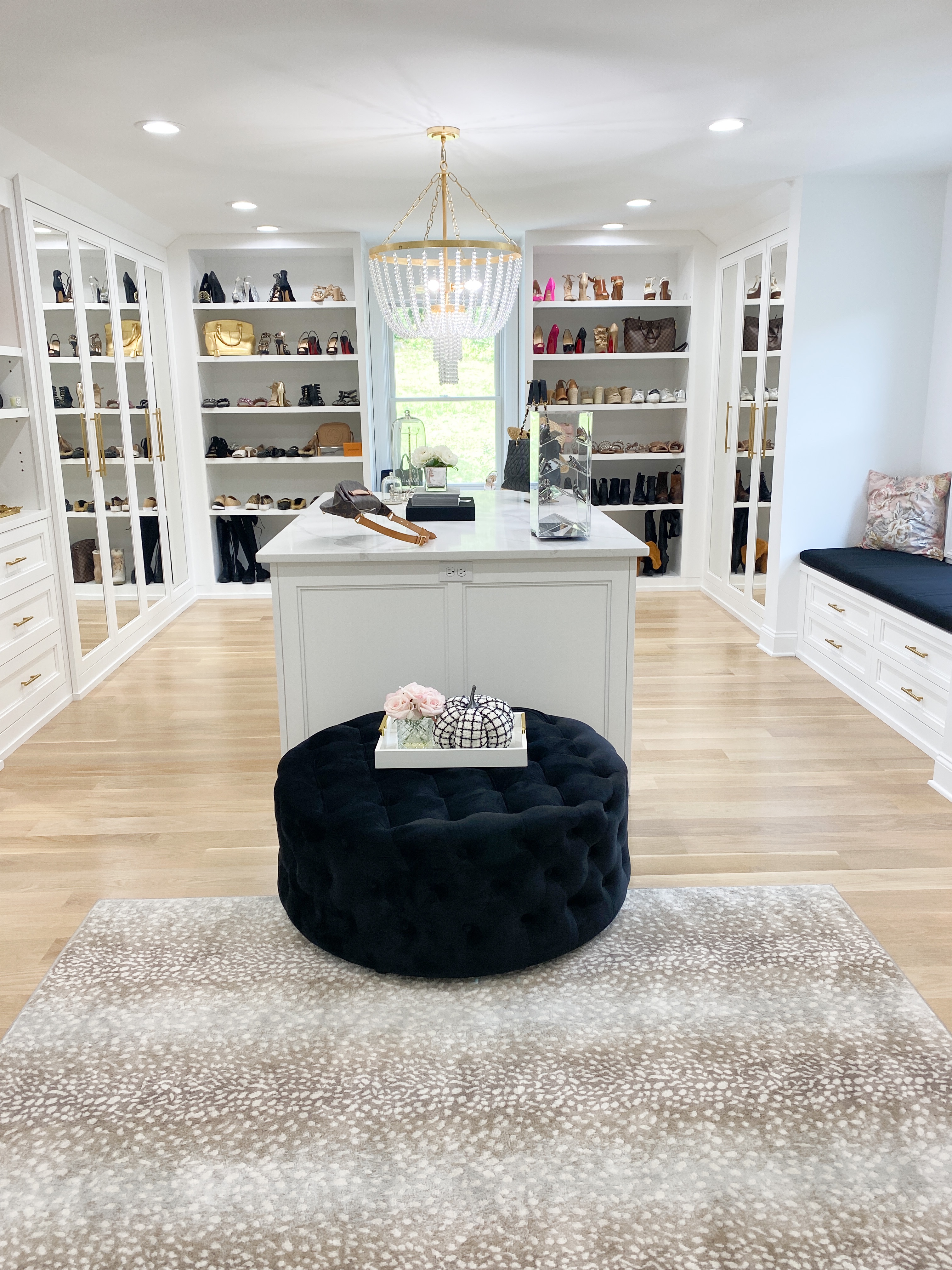 Custom Closet Reveal with white walls. a center closet, and spacious