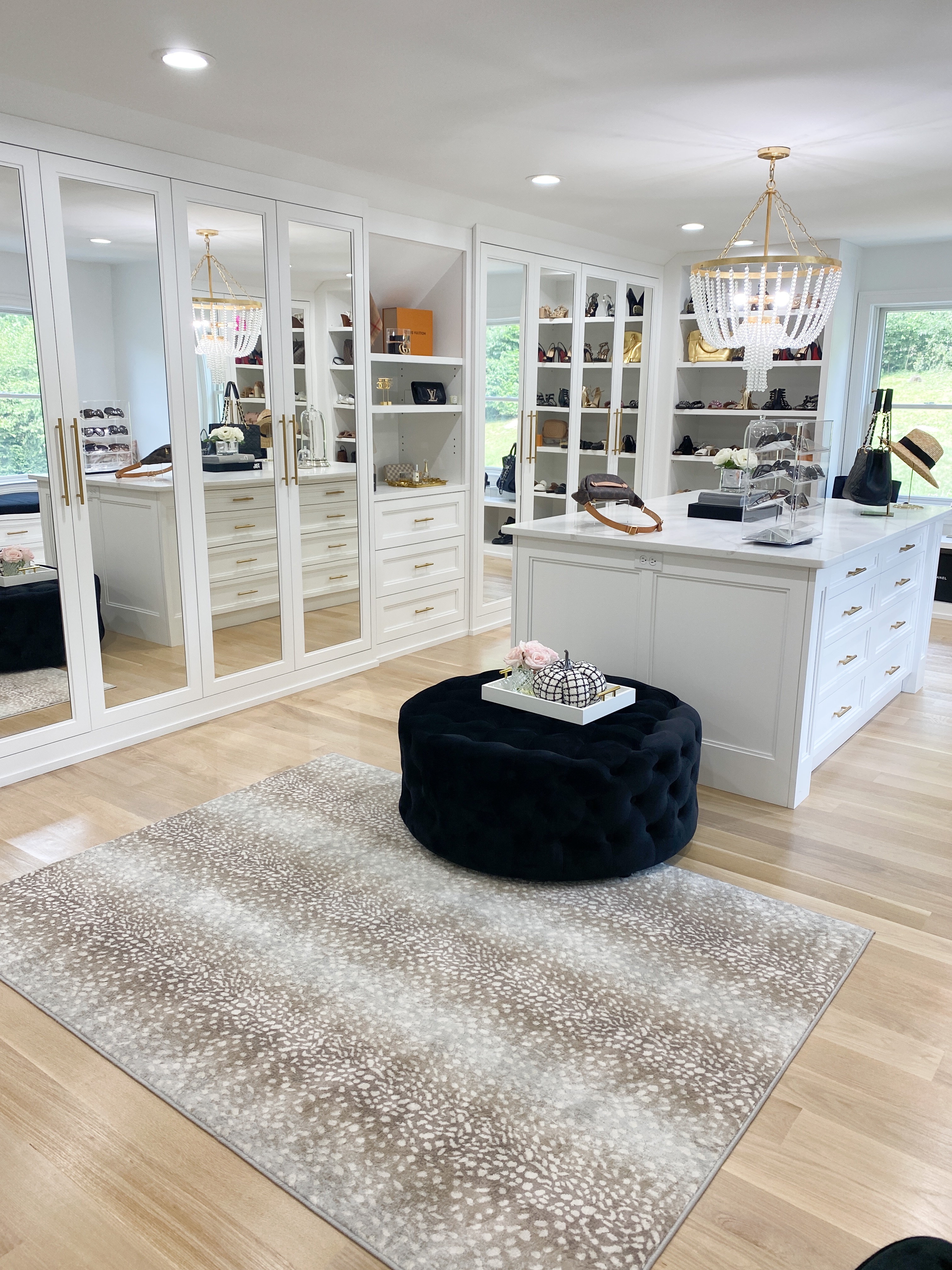 ottoman, an island, and mirrors in Custom Closet Reveal